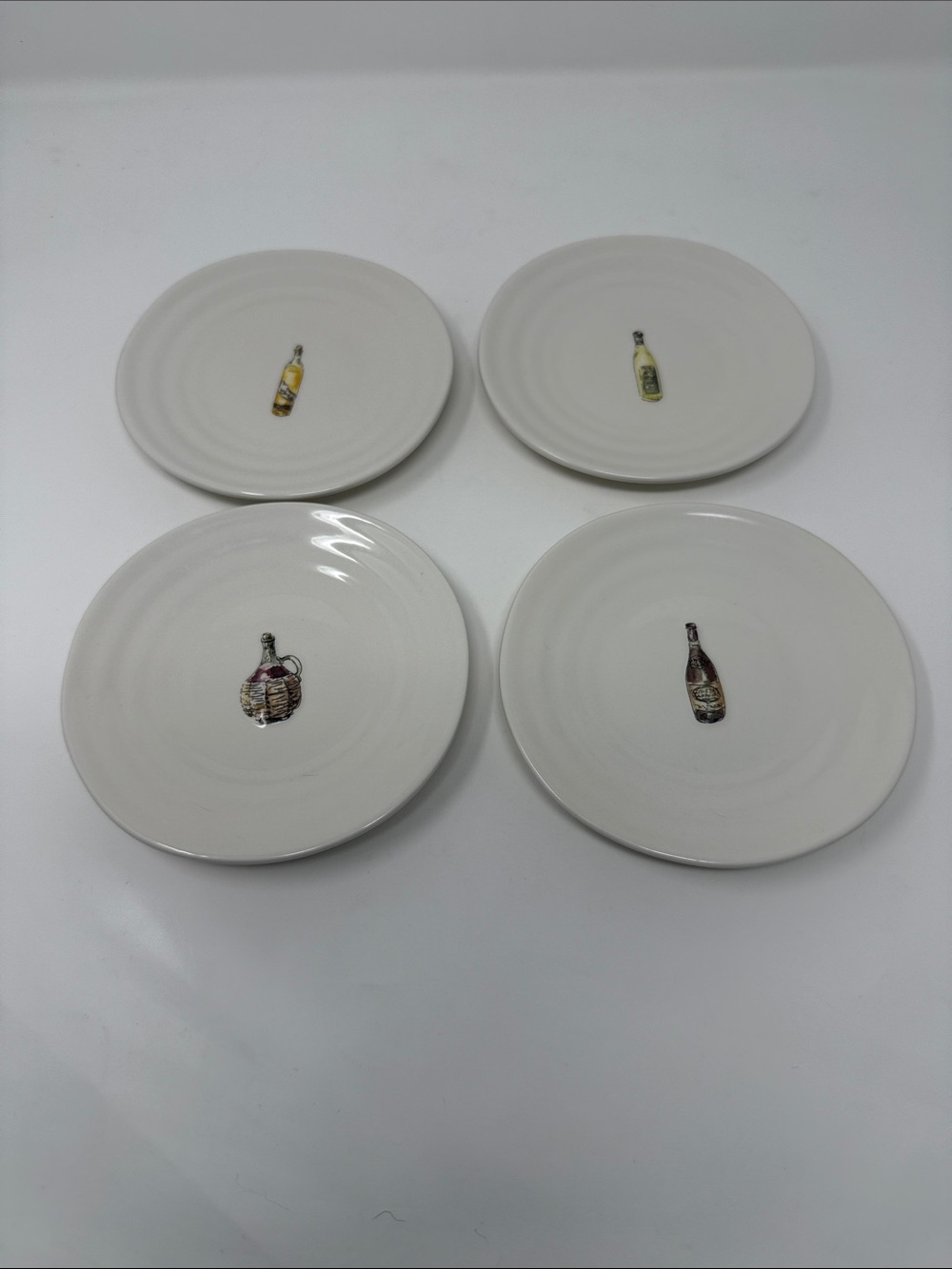 Williams Sonoma Cream Ceramic Dinner Plates with Wine Bottle Motifs - Set of 4